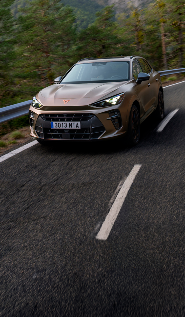 A CUPRA Terramar SUV shown from a high angle, appearing to be in motion with a red light streak extending from its side to a person lying horizontally in the air next to it.